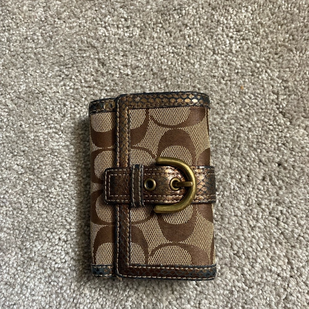I have a Brown Coach Trifold wallet, not the best condition but still useable!